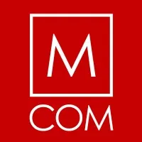 M COM